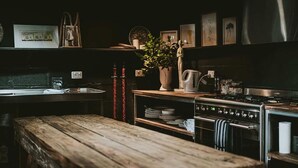 A kitchen with a wooden bench, a stove, a kettle, and various kitchen utensils. - The Stables Daylesford ~ Incredible Property! (Daylesford)