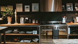 A modern kitchen with stainless steel appliances, wooden countertops, and a variety of kitchenware. - The Stables Daylesford ~ Incredible Property! (Daylesford)