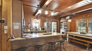 A kitchen with wooden walls, a granite countertop, and bar stools. - Secluded Cabin, Comfortable Lux, Valley View ~ Canaan Valley & Seneca (Harman)