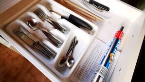 A kitchen drawer with utensils and a can of spray paint. - MERIKOTKA: cozy wooden cottage sLOVEnia with farm view & wonderful neighborhoods (Braslovče)
