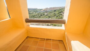 A balcony with a view of a cityscape. - Coto Real Andros 201 (Manilva)