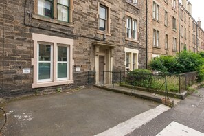 Stunning corner building with a ground-level entrance and charming porch area.