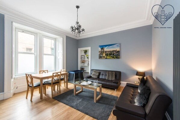 Enjoy meals and drinks by the window in this inviting living space with a comfortable sofa and dining area.