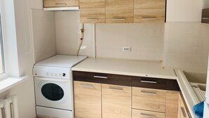 A compact kitchen with wooden cabinets, a built-in oven, and a countertop. - Center. 1. 2 km to Deribasovskaya (Odesa)