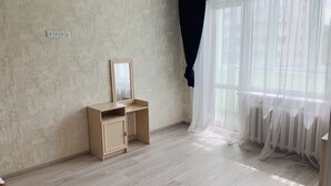 A room with a wooden desk, a mirror, and a window with sheer curtains. - Center. 1. 2 km to Deribasovskaya (Odesa)