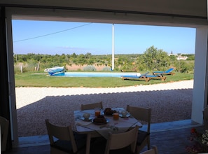 Enjoy meals with a view of the pool and garden from this dining area.
