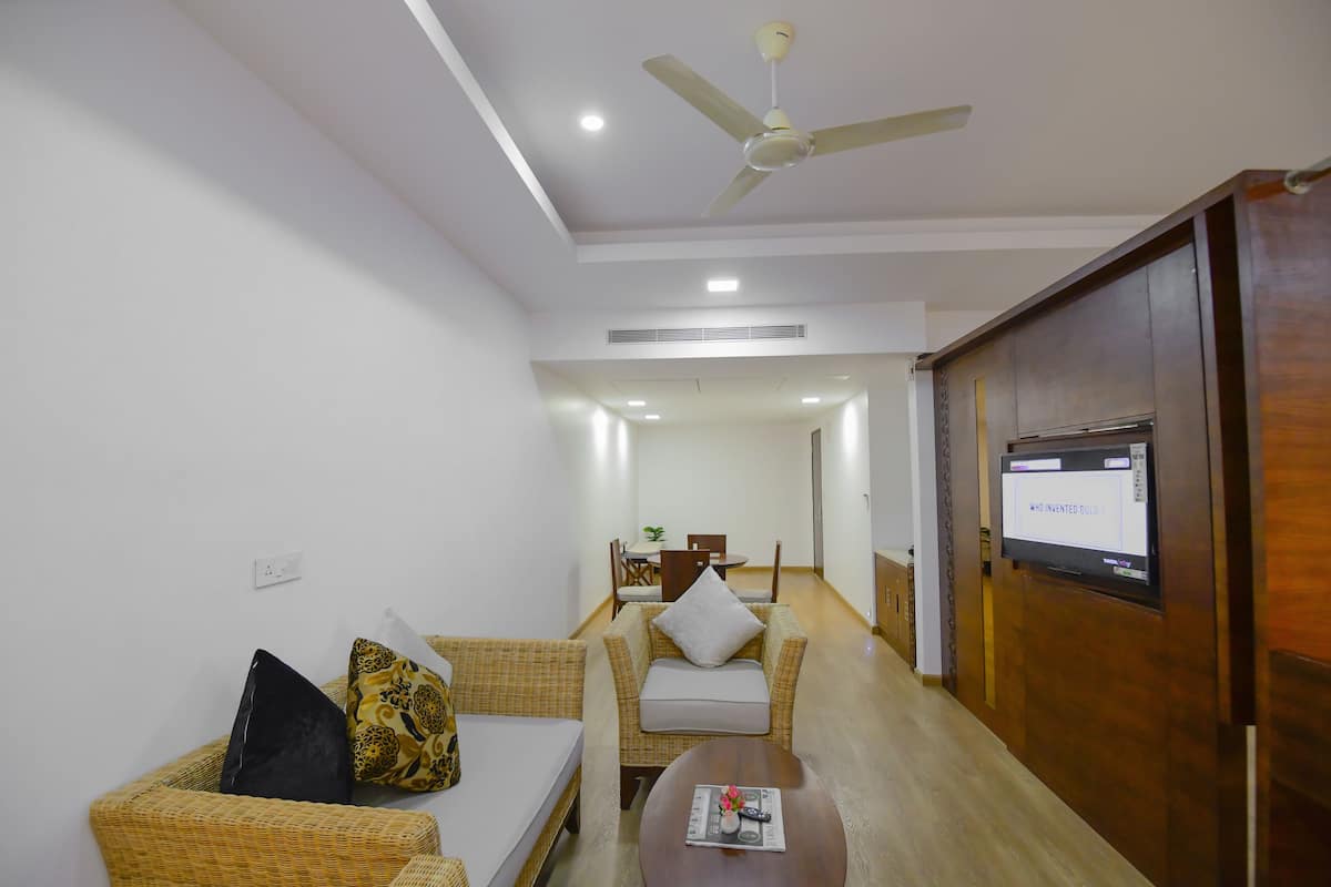Luxury Suite, 1 Bedroom | Living area | 42-inch flat-screen TV with satellite channels, TV