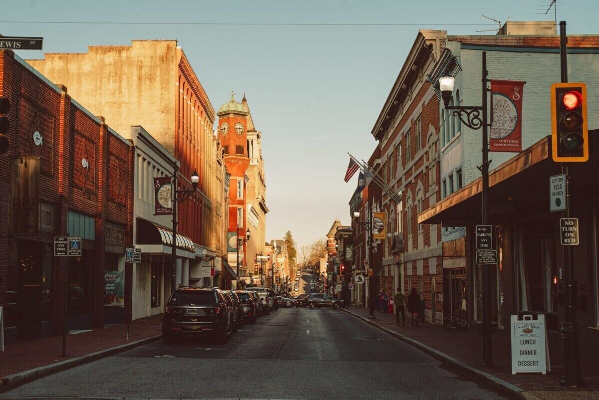 A street lined with historic buildings, a clock tower, and a sign for 'Historic Downtown'.
