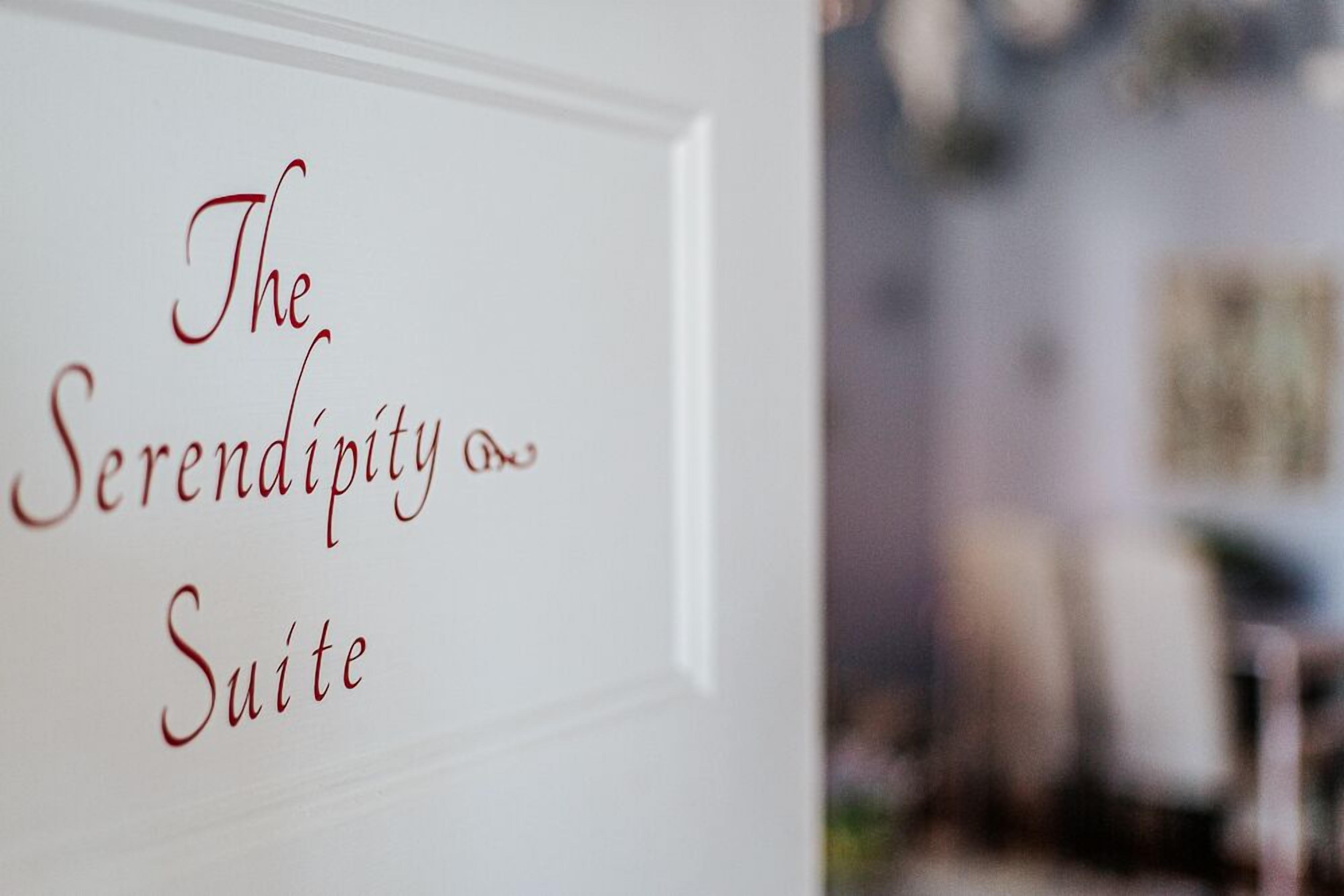 A sign with the text 'The Serendipity Suite' indicating the name of a hotel room or suite.
