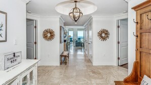 A hallway with a suggestion box, wooden decor, and a view to a dining area.