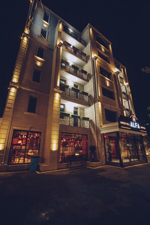 A multi-story hotel with balconies, a visible entrance, and a sign reading "Alfa Hotel." - Alfa Hotel & Hostel (Baku)