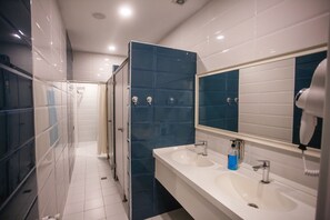 A modern bathroom with two sinks, a mirror, and a hairdryer. - Alfa Hotel & Hostel (Baku)