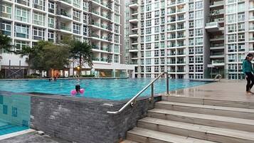 Guests can enjoy a refreshing swim in the pool, accessible via stairs with a handrail.