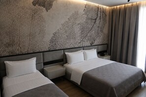 A hotel room with two beds, a large abstract wall art, a nightstand, and a window with curtains. - Lord Hotel & Restaurant at AutoStation (Preze)