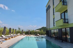 A hotel with a swimming pool, sun loungers, and outdoor seating. - Lord Hotel & Restaurant at AutoStation (Preze)