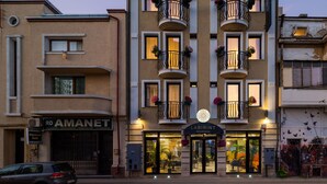 A hotel with multiple balconies, a sign reading "LABIRINT RESIDENCE," and a visible entrance with a glass door. - Labirint Hotel (Bucharest)