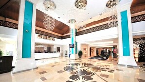 A spacious lobby with a polished marble floor, a reception desk, and a staircase. - Wonderland Villa at Port Dickson (Port Dickson)