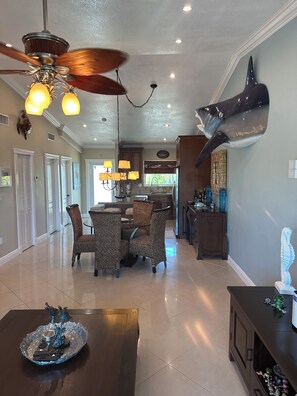 Enjoy family meals together at the dining table, surrounded by a unique fish sculpture and natural light.