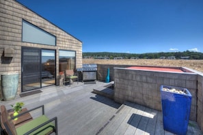 A modern outdoor deck with a barbecue grill, seating area, and a hot tub. - Seale - Sea Ranch 2BR Oceanfront Home (Sea Ranch)
