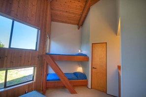 A room with a bunk bed, a window, and a door. - Kenber House – Don Jacobs Coastal Near Shell Beach (Sea Ranch)