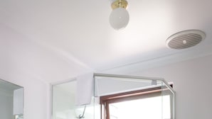 A modern bathroom with a glass-enclosed shower, a white toilet, and a sink with a mirror above it. - Cozy Studio Chalet perfect for couples and a veranda overlooking the bushland (Margaret River)