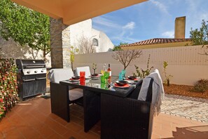 Enjoy al fresco dining at this patio with a grill and comfortable seating for four.