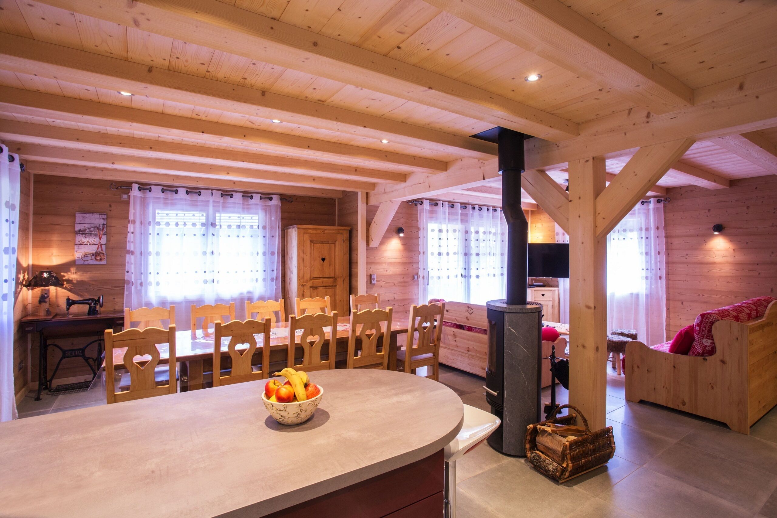 Un intérieur en bois comprenant un coin repas, un canapé et une cheminée.