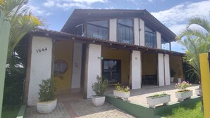 A two-story building with a balcony, a number '1844' on the wall, and a gated entrance. - Pousada Chef Brasil (Barra Velha)