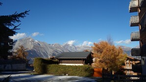 A traditional wooden building with a sloped roof, surrounded by snow-covered ground and a mountain backdrop. - Pracondu 2 304 - OUTDOOR & FUN  apartment 6 pers (Haute-Nendaz)