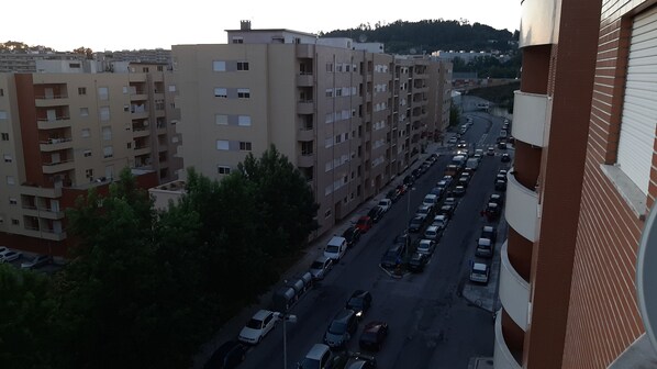 A multi-story residential building with a parking lot in front.
