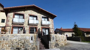 A stone building with a staircase leading to a balcony. - Studio with Jacuzzi "Balcony of the Len" (Soba)