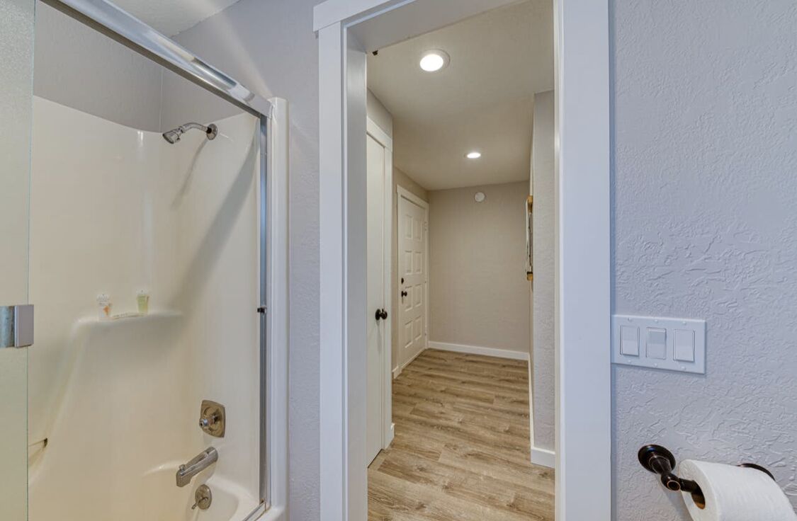 A bathroom with a shower, toilet, and sink.