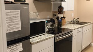 A modern kitchen with stainless steel appliances, white cabinetry, and a granite countertop. - Luxury Lake Suite  9 Hole & Disc Golf with Hot Tub, Views, Large Patios. (Dos Rios)
