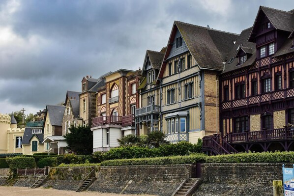 A row of traditional European-style buildings with steeply pitched roofs and timber framing.
