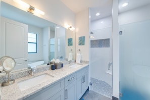 Bathtub, rainfall showerhead, hair dryer, towels