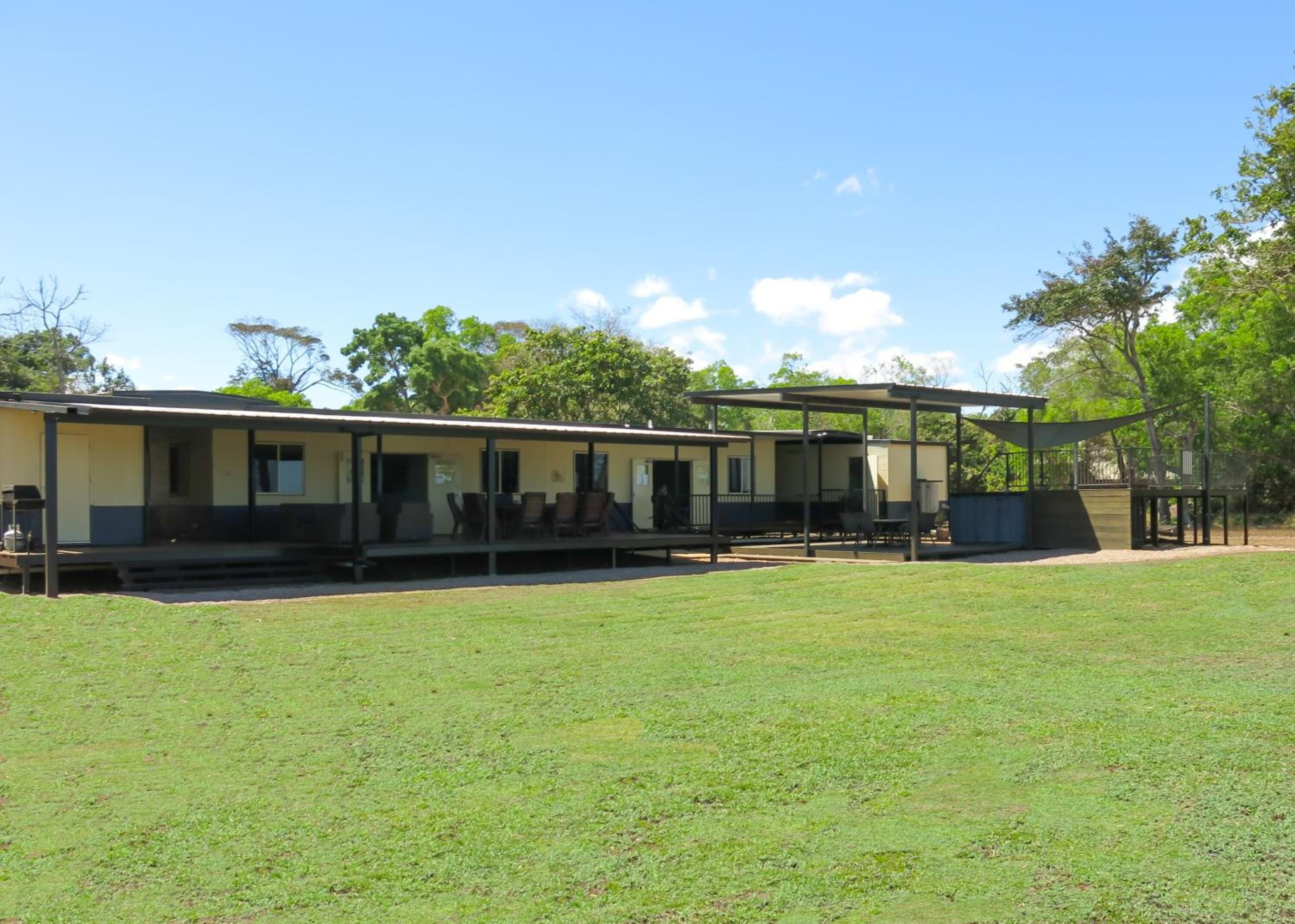 A mobile home with a porch and outdoor seating area.