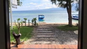 A wooden deck leading to a beach with a sign reading "CABANA" and "NO VACANCY". - Cabana (Gili Air)