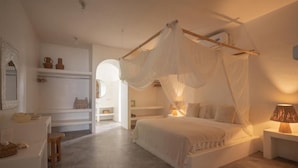 A bedroom with a canopy bed, a bedside table with a lamp, a wardrobe, and a mirror. - Cabana (Gili Air)