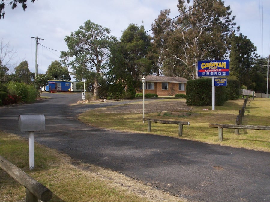 A caravan park sign, a building labeled "Office," and a mailbox.
