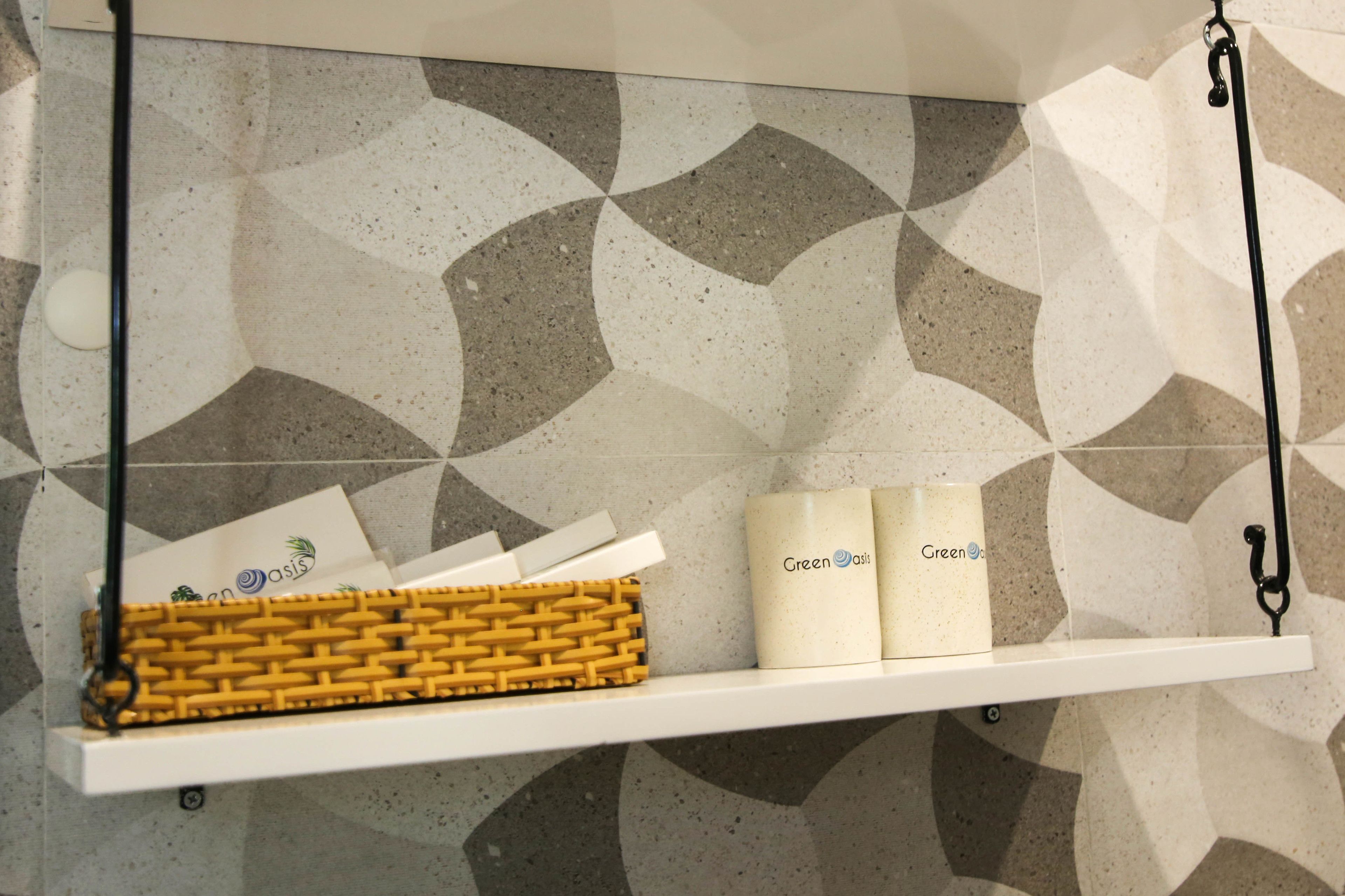 A shelf with a woven basket and two containers labeled "Green Oasis."