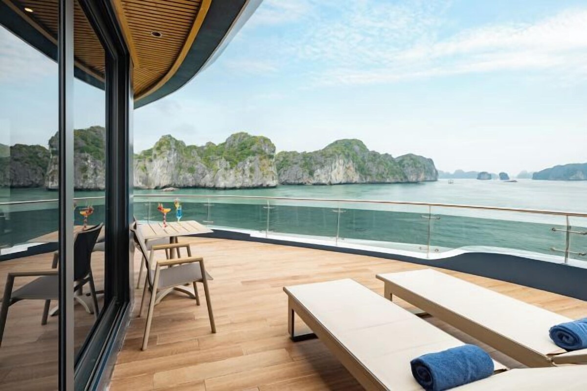 Una terraza con asientos y vista al mar.
