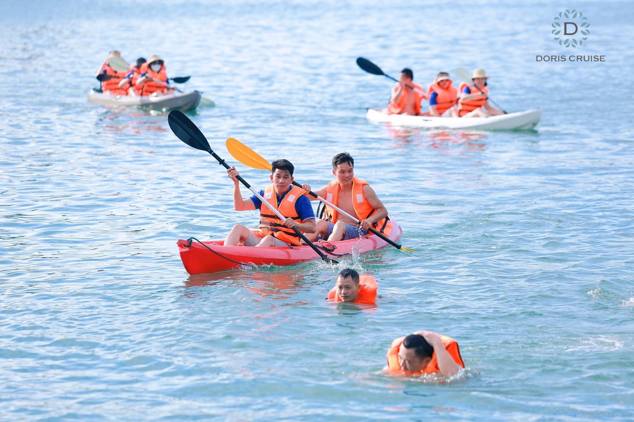 A group of people kayaking on a calm body of water.