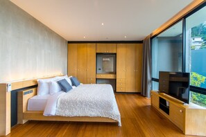 A modern bedroom with a large bed, wooden wardrobe, and a TV on a wooden stand. - Modern Property Nearby Kamala Beach W Pool (Kamala)