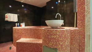 A bathroom with a large, round sink and a mirror above it. There are toiletries on a shelf and a towel hanging on the wall. - Hotel Yaja Suwon City Hall (Suwon)