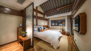 A modern hotel room with a large bed, wooden accents, a view of the city, and a small table with a vase. - SSAW Boutique Hotel Nanjing Qifeng Confucius House (Nanjing)