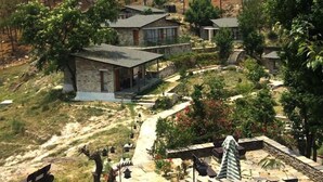A modern house with a stone facade, a covered porch, and a stone staircase leading to a second level. - Queens Meadows by Sunshine & Smiles (Ranikhet)