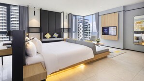 A modern hotel room with a large bed, a desk, and a TV. - Anya Beach Hotel Quy Nhon (Quy Nhon Nam)