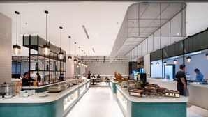 A modern restaurant with a central island, multiple hanging lights, and a clean, spacious layout. - Anya Beach Hotel Quy Nhon (Quy Nhon Nam)