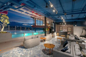 A rooftop lounge with a pool, seating areas, and a bar. - The Zuri Dumai (Dumai)