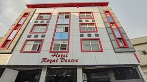 Hotel Royal Desire with a modern facade, multiple windows, and a prominent sign. - Treebo Trend Royal Dizire (Udaipur)
